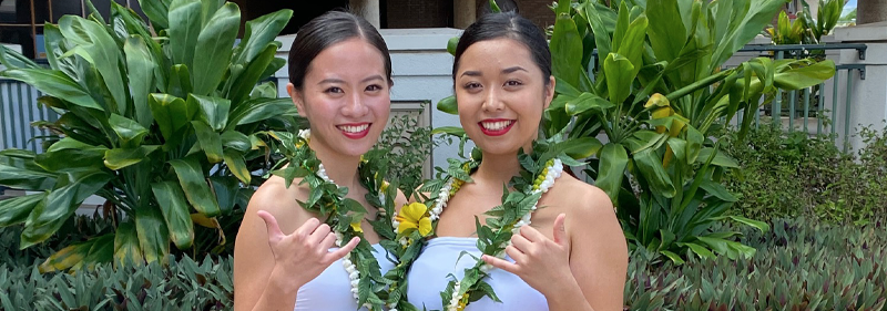 two female students with lei posing for camera