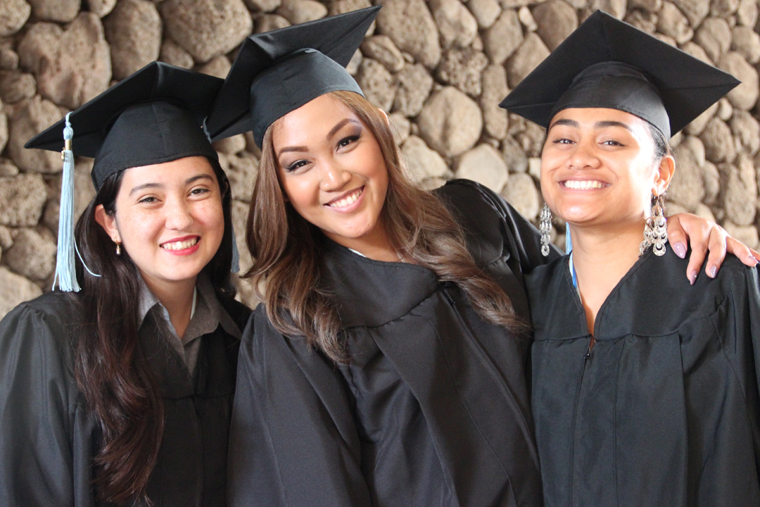 about-more_programs three female graduates in cap and gown