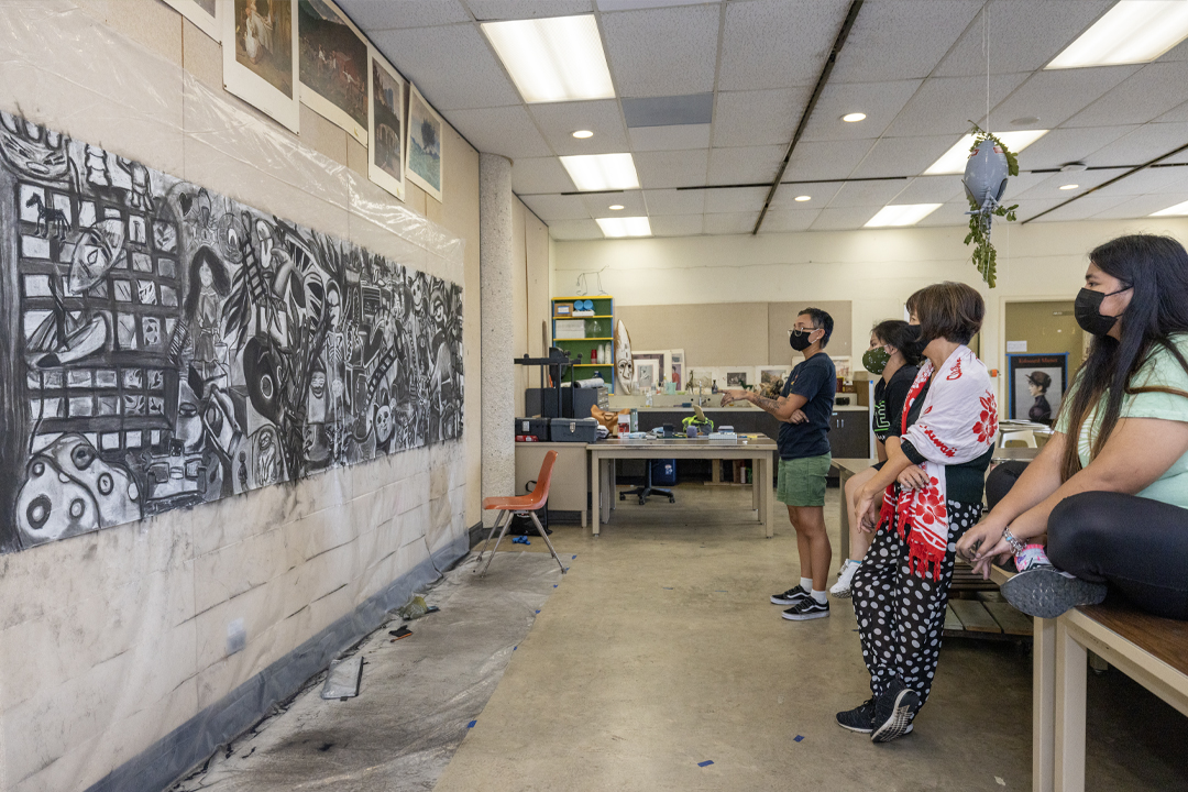 Drawing students viewing art project mounted to wall