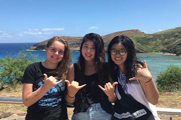 Three female international students at beach