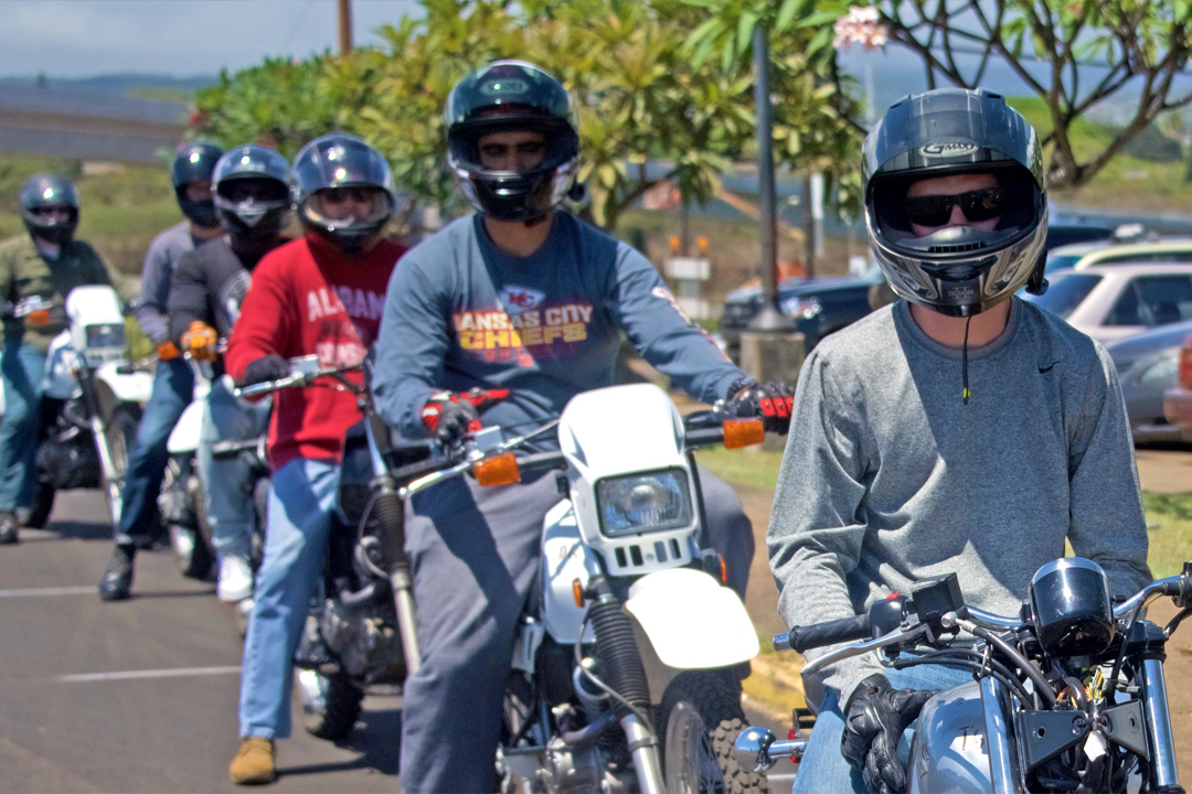 motorcycle students on bikes lined up in parking lot