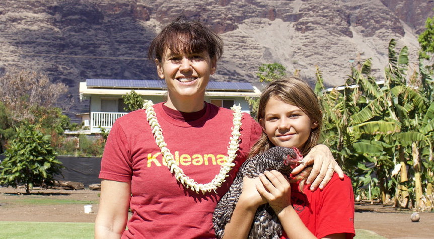 Synnora Regehr of Makaha Eggs & Moa, with young workshop participant, holding an adult chicken